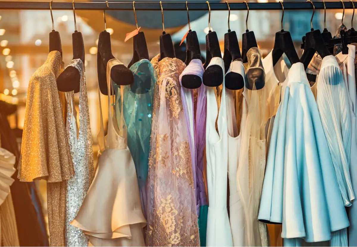 Lots of clothes hanging on a pole